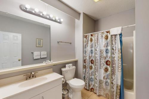 a bathroom with a toilet and a shower curtain at Waves Crest 338 IC in Avon