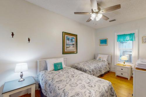 a bedroom with two beds and a ceiling fan at Waves Crest 338 IC in Avon