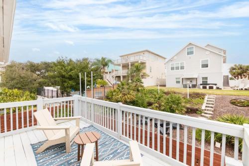 a balcony with a chair and a house at 4BR house, 2 blocks from the beach in St. Augustine
