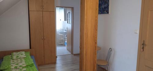 a room with a bedroom with a table and a bathroom at Kaszubskie Nuty in Miechucino