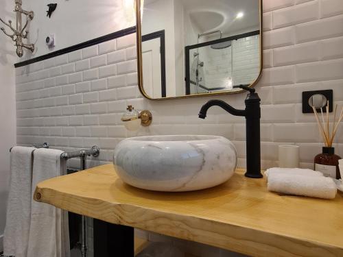 a bathroom with a large marble sink on a wooden table at Échappée Enchantée dans une Ancienne Gare au Bord de la Forêt d'Orléans - FR-1-590-268 in Combreux