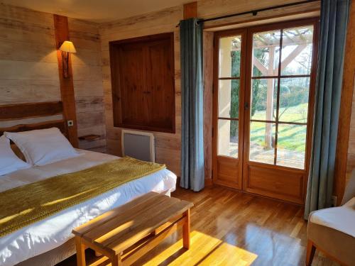 a bedroom with two beds and a window at Chambre familiale au cœur de la nature avec jardin et piscine privée, idéale pour explorer le Loiret - FR-1-590-265 in Vitry-aux-Loges