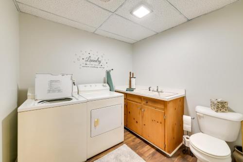 a bathroom with a washing machine and a sink at Charming Emporia Home with Deck and Patio! in Emporia