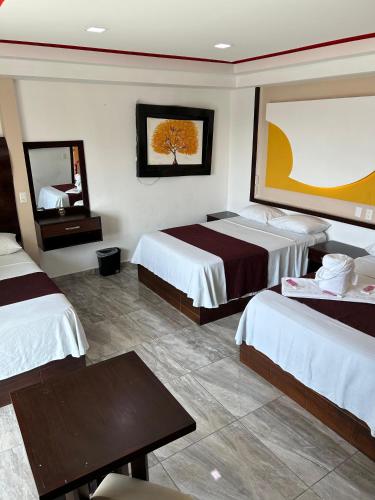 Ein Bett oder Betten in einem Zimmer der Unterkunft Real Caribe Inn