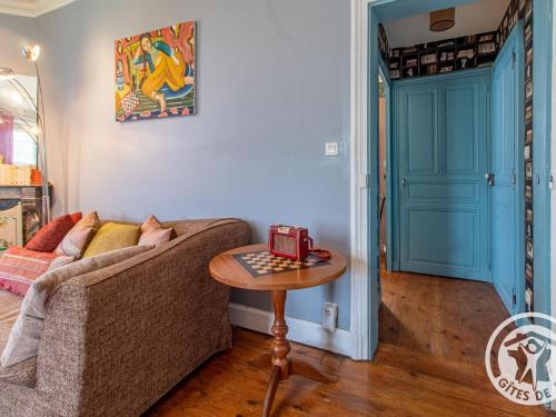 a living room with a couch and a table at Maison de maître avec piscine et jardin - cœur des Coteaux du Layon, proche Angers et Saumur - FR-1-622-55 in Faye-dʼAnjou