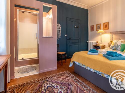 a bedroom with a king sized bed and a walk in shower at Maison de maître avec piscine et jardin - cœur des Coteaux du Layon, proche Angers et Saumur - FR-1-622-55 in Faye-dʼAnjou