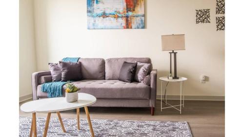 a living room with a couch and a table at Stunning Nulu 1BR CozySuites 03 in Louisville