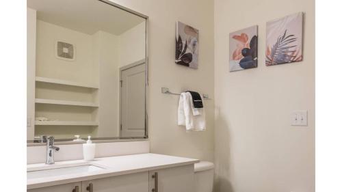 a bathroom with a sink and a mirror at Stunning Nulu 1BR CozySuites Unit 03 in Louisville