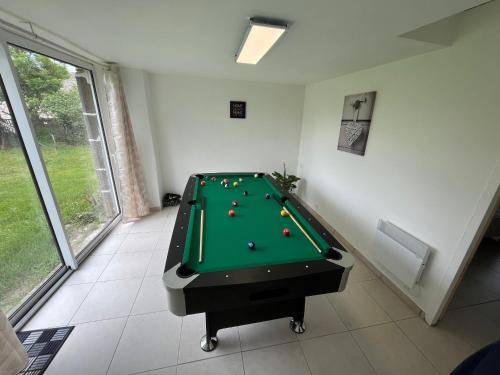 a room with a pool table with balls on it at Maison de vacances rénovée à la ferme, terrasse, proche du Parc Ardes, Puy de Dôme et Brioude - FR-1-582-375 in Autrac