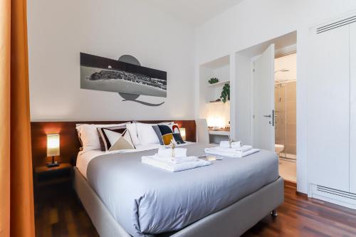 a bedroom with a large bed with two trays on it at B&B Qaral in Cagliari