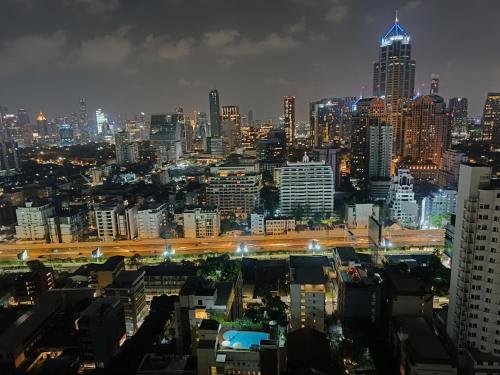 a view of a city at night with at Affordable Serviced Apartments in Nana Omni Tower - Prime Sukhumvit location in Bangkok