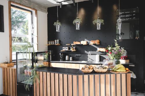 a kitchen with black walls and a counter with bread at Debed Life CoLiving and Retreat in Debed