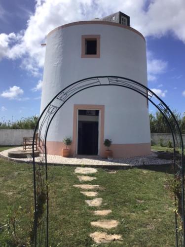 a white lighthouse with an arch in front of it at The Olive Mill in Bombarral