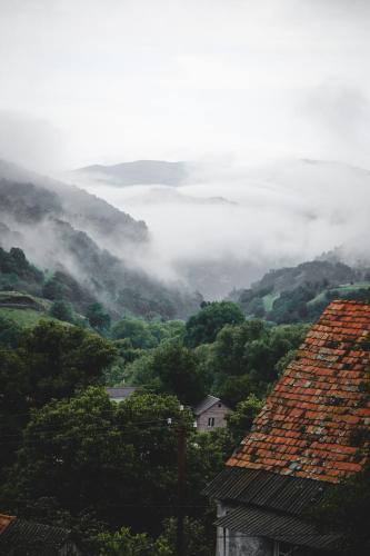 a view of a misty valley with houses and trees at Debed Life CoLiving and Retreat in Debed