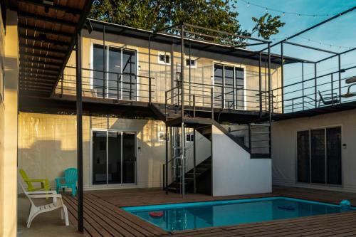a house with a staircase next to a swimming pool at Emi’s Place Container Living in Uvita