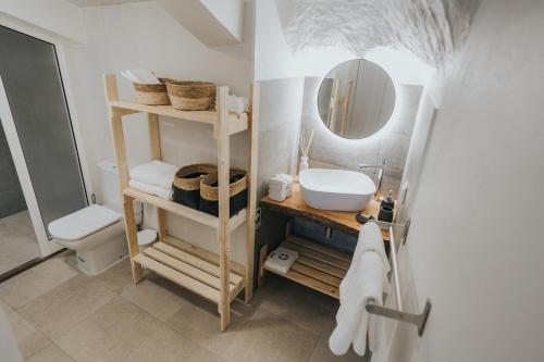 ein Bad mit einem Waschbecken und einem Spiegel in der Unterkunft Pico Apartment's in Câmara de Lobos
