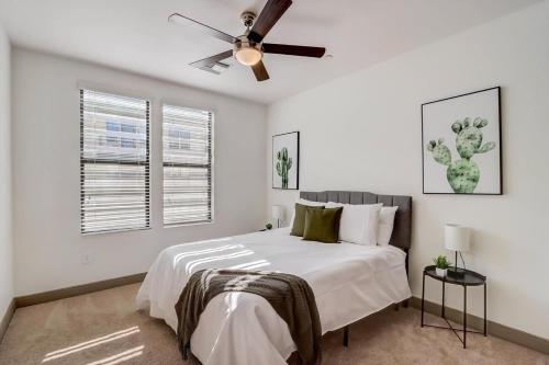 a white bedroom with a bed and a ceiling fan at Modern CozySuites on the Town Lake waterfront 18 in Tempe
