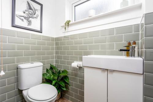 a bathroom with a white toilet and a sink at 33 Lochgreen Avenue in Troon
