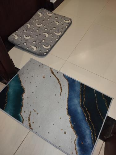 a pair of rugs on the floor in a room at Serene Bliss Villa in Unawatuna