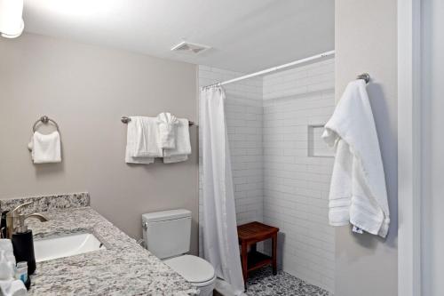 a bathroom with a shower and a toilet and a sink at Loggerhead 261 in Sanibel