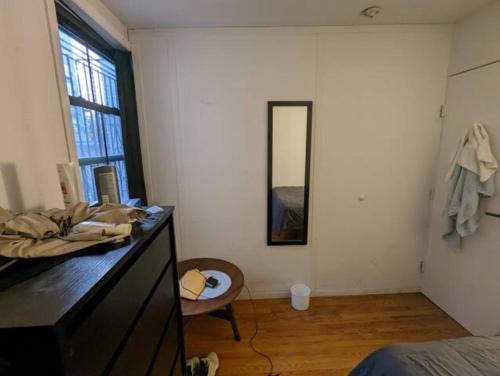 a bedroom with a dresser and a mirror on the wall at Comfy Room at great Townhouse in Williamsburg in Brooklyn