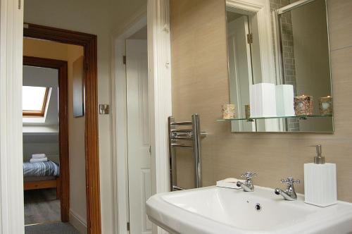 a bathroom with a sink and a mirror at Idris View Family Holiday Home in Tywyn