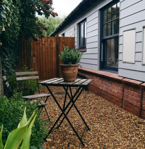a potted plant sitting on a table in a garden at Secret Mersea Retreat - a stroll from the anchorage! in West Mersea