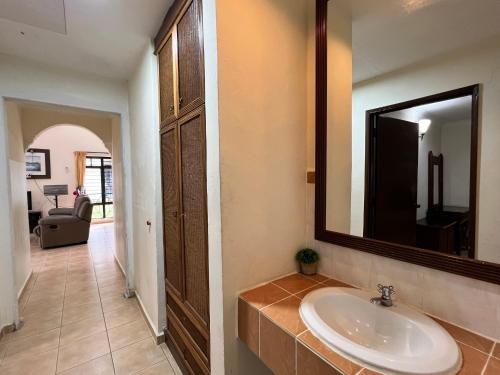 a bathroom with a sink and a mirror at Private Pool Villa Lot 872 - Fong Homestay in Kampong Alor Gajah