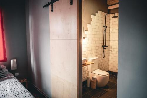 a small bathroom with a toilet and a shower at Debed Life CoLiving and Retreat in Debed