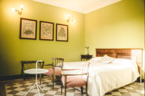 a bedroom with a bed and a table and chairs at Azienda agricola La Macina in Bregnano