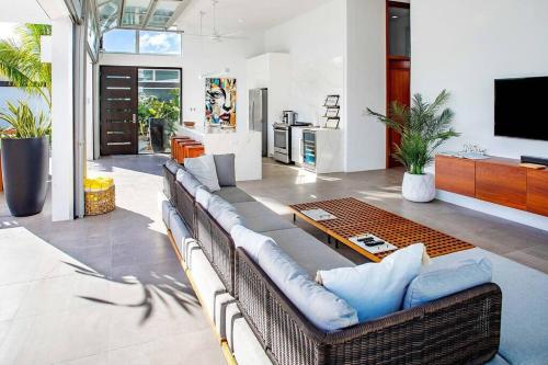a living room with a couch and a table at Beachside 4 Bedroom Villa with Pool and Resort Amenities - White Villas - v9 in Long Bay Hills