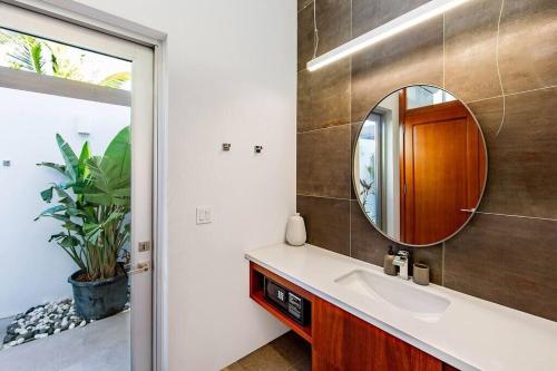 a bathroom with a sink and a mirror at Beachside 4 Bedroom Villa with Pool and Resort Amenities - White Villas - v9 in Long Bay Hills