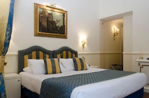 Postel nebo postele na pokoji v ubytování Hotel Traiano