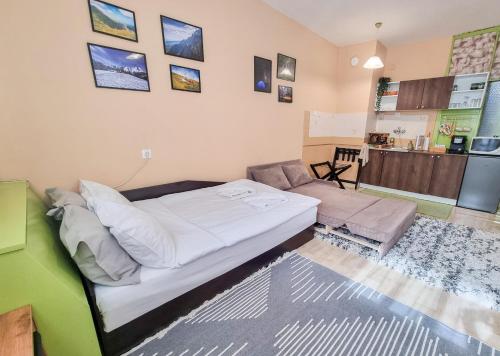 a bedroom with a bed and a living room at Студио апартамент Троян in Troyan