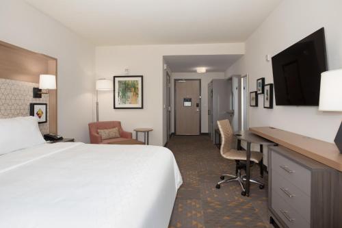 a hotel room with a bed and a desk at Holiday Inn Glendale - Stadium & Ent Dist by IHG in Glendale