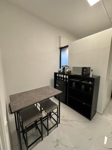 a table and chairs in a room with a microwave at Cernusco luxury Milanese apartment in Cernusco sul Naviglio