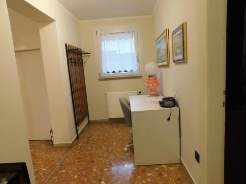 a room with a white refrigerator and a window at Casa dolce casa in Aviano