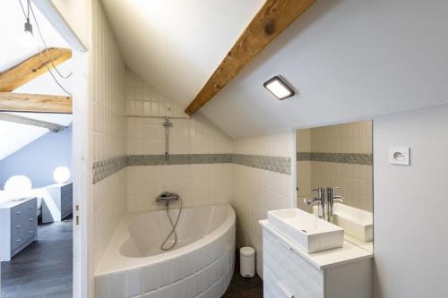 a white bathroom with a tub and a sink at Superbe villa familiale - 1408 in Esterre