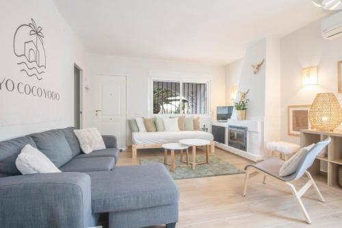 a living room with a couch and a table at Cayo Coco Yodo - 2 min walk to the beach in Torreguadiaro
