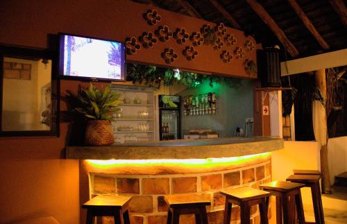 a bar in a restaurant with stools in front of it at Vista Do Deus Resort in Ligogo