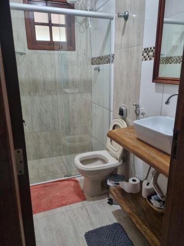y baño con aseo, ducha y lavamanos. en Casa da Seriema em Lapinha da Serra en Santana do Riacho