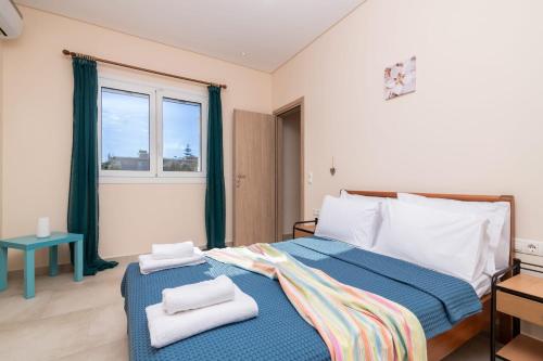 a bedroom with a large bed with towels on it at Splendid Zakynthos Villa - 2 Bedrooms - Ocean Pool Villa - Close to Amenities - Walking Distance to Beach in Tsilivi