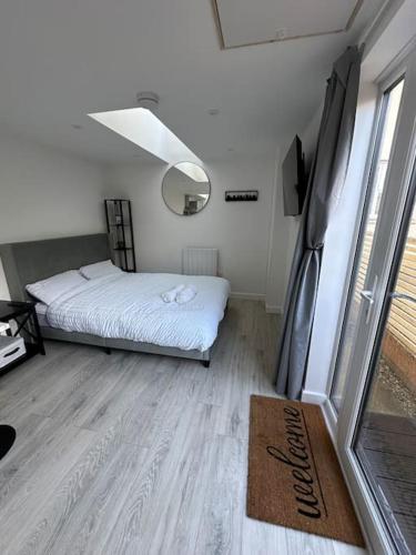 a small bedroom with a bed and a window at Whitsun Studio - Brand New listing! in Bristol