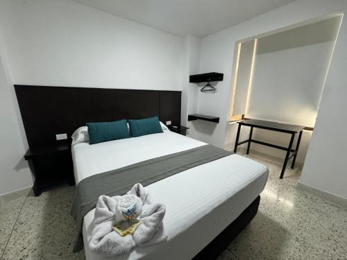 Una cama o camas en una habitación de Hotel Mar Inn Cali