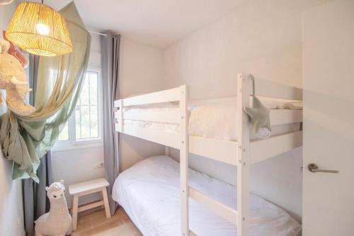 a bedroom with two bunk beds and a window at Cayo Coco Yodo - 2 min walk to the beach in Torreguadiaro