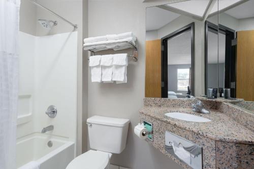 a bathroom with a toilet and a sink and a mirror at Stay 2Night Chattanooga Hamilton Place in Chattanooga