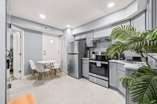 a kitchen with stainless steel appliances and a table at Cozy Apt in Center City! in Philadelphia