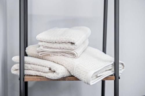 a pile of towels sitting on a shelf at New! Cozy Apt in Center City! in Philadelphia