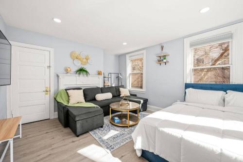 a living room with a bed and a couch at New! Cozy Apt in Center City! in Philadelphia