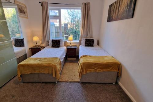 a room with two beds and a window at Forest view cottage in Nottingham